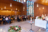 Blick vom Taufbecken in Richtung Kirchenraum, wo die Gemeinde ein Tauflied singt.