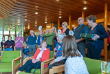 Mitarbeiterinnen und Mitarbeiter der Trinitatiskirche stehen im Halbkreis im Foyer der Kirche und applaudieren.